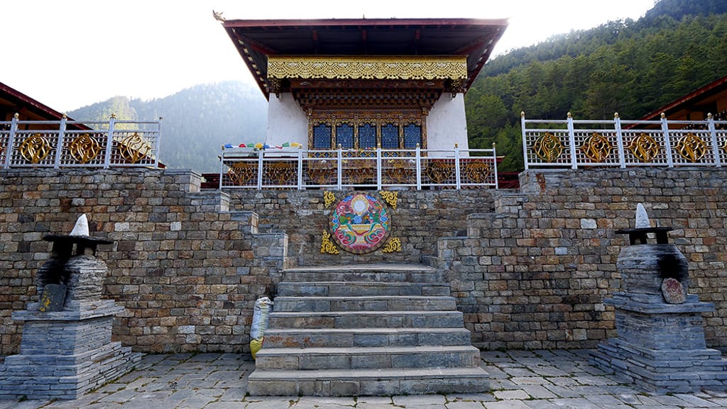 Karpo Lhakhang, White Monastery in Haa Valley, Bhutan, with prayer flags and monks
